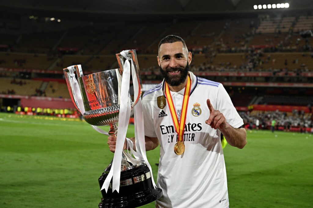 Real Madrid's French forward Karim Benzema holds the King's Cup trophy at the end of the Spanish Copa del Rey (King's Cup) final football match between Real Madrid CF and CA Osasuna at La Cartuja stadium in Seville on May 6, 2023.