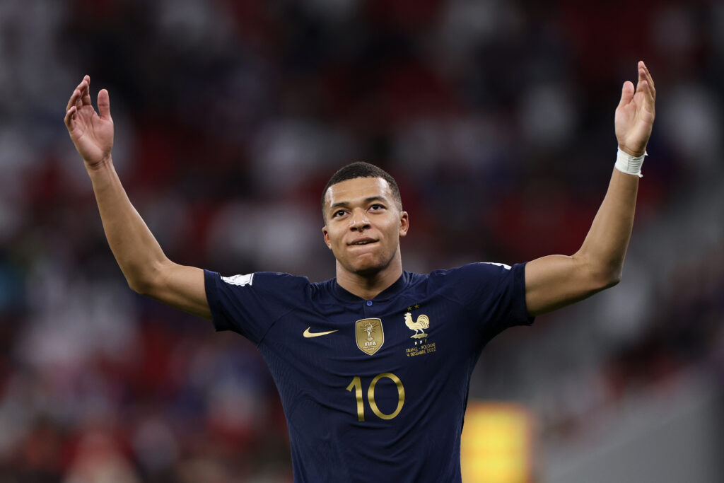 DOHA, QATAR - DECEMBER 04: Kylian Mbappe of France celebrates after scoring the team's third goal during the FIFA World Cup Qatar 2022 Round of 16 match between France and Poland at Al Thumama Stadium on December 04, 2022 in Doha, Qatar.