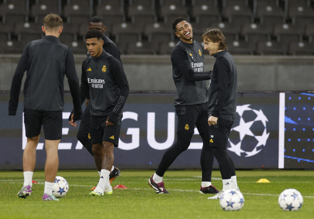 Real Madrid's English midfielder #05 Jude Bellingham and Real Madrid's Croatian midfielder #10 Luka Modric joke as they attend a training session in Berlin on December 11, 2023, on the eve of the UEFA Champions League Group C match Union Berlin vs Real Madrid CF.