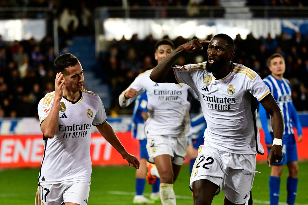 TOPSHOT - Real Madrid's Spanish forward #17 Lucas Vazquez celebrates with Real Madrid's German defender #22 Antonio Rudiger after scoring his team's first goal during the Spanish league football match between Deportivo Alaves and Real Madrid CF at the Mendizorroza stadium in Vitoria on December 21, 2023.