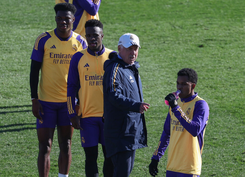 From L) Real Madrid's French defender #18 Aurelien Tchouameni, Real Madrid's Brazilian forward #07 Vinicius Junior, Real Madrid's Italian coach Carlo Ancelotti and Real Madrid's Brazilian forward #11 Rodrygo attend a training session at the Ciudad Real Madrid training ground in Valdebebas, Madrid, on December 30, 2023.