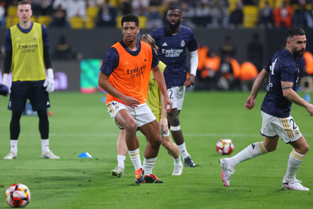 Real Madrid's English midfielder #5 Jude Bellingham and Real Madrid's Spanish defender #02 Dani Carvajal warm up ahead of the Spanish Super Cup semi-final football match between Real Madrid and Atletico Madrid at the Al-Awwal Park Stadium in Riyadh, Saudi Arabia, on January 10, 2024.