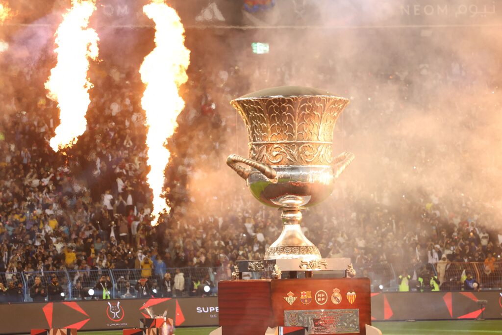 A giant replica of the trophy is put up on display on the pitch before the start of the Spanish Super Cup final football match between Real Madrid CF and FC Barcelona at the King Fahd International Stadium in Riyadh, Saudi Arabia, on January 15, 2023.