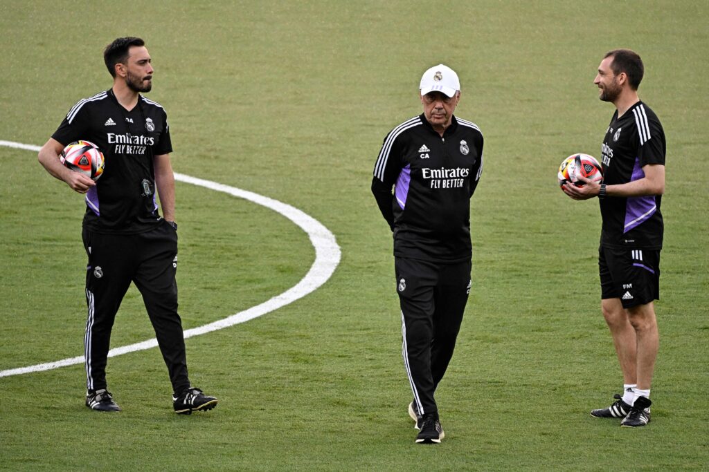 Real Madrid's Italian coach Carlo Ancelotti (C) and Real Madrid's Italian assistant coach Davide Ancelotti (L) attend a training session at la Cartuja stadium in Seville on May 5, 2023, on the eve of the Spanish Copa del Rey (King's Cup) final football match between Real Madrid CF and CA Osasuna.