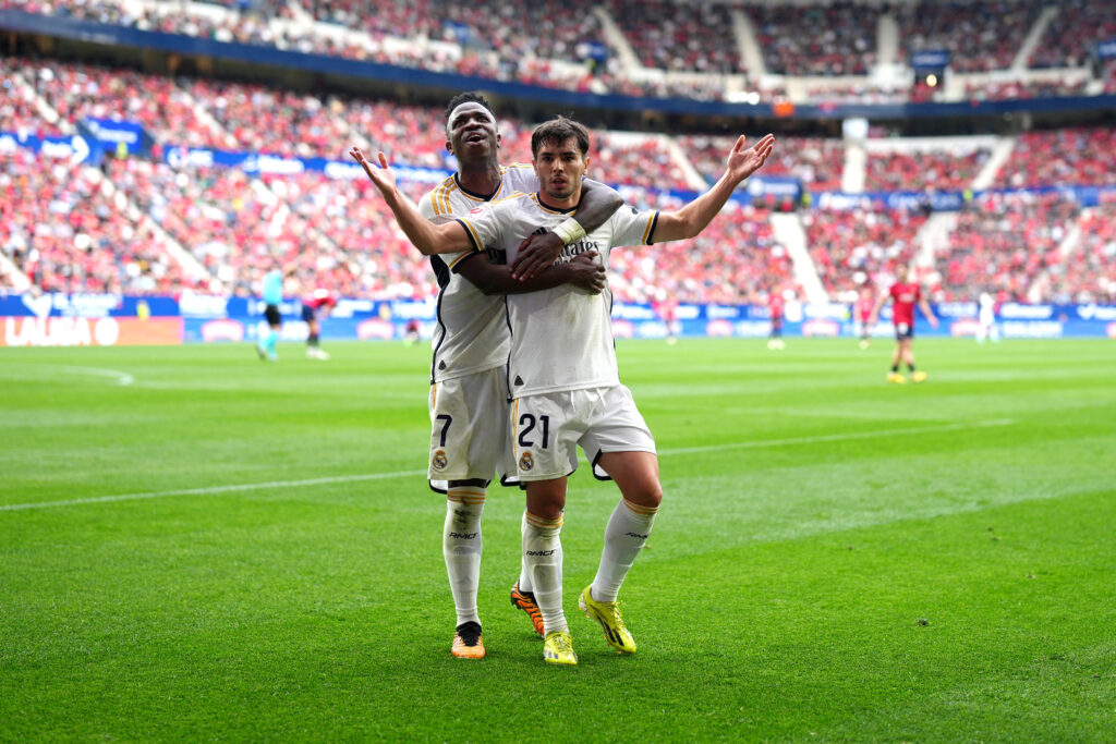 PAMPLONA, SPAIN - MARCH 16: Brahim Diaz of Real Madrid celebrates scoring his team's third goal with teammate Vinicius Junior during the LaLiga EA Sports match between CA Osasuna and Real Madrid CF at Estadio El Sadar on March 16, 2024 in Pamplona, Spain.