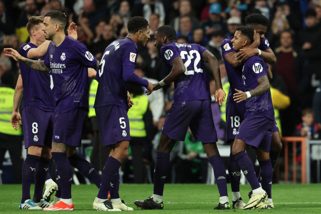 CORRECTION / Real Madrid's Brazilian forward #11 Rodrygo (2nd-R) celebrates with teammates after scoring his team's second goal during the Spanish league football match between Real Madrid CF and Athletic Club Bilbao at the Santiago Bernabeu stadium in Madrid on March 31, 2024.