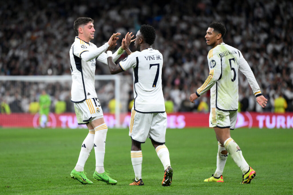 MADRID, SPAIN - APRIL 09: Federico Valverde of Real Madrid celebrates scoring his team's third goal with teammate Vinicius Junior during the UEFA Champions League quarter-final first leg match between Real Madrid CF and Manchester City at Estadio Santiago Bernabeu on April 09, 2024 in Madrid, Spain.