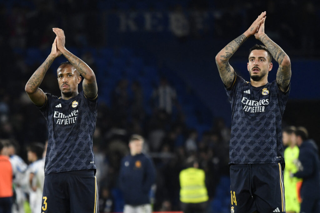 Real Madrid's Brazilian defender #03 Eder Militao (L) and Real Madrid's Spanish forward #14 Joselu celebrate their victory at the end of the Spanish league football match between Real Sociedad and Real Real Madrid CF at the Anoeta stadium in San Sebastian on April 26, 2024.