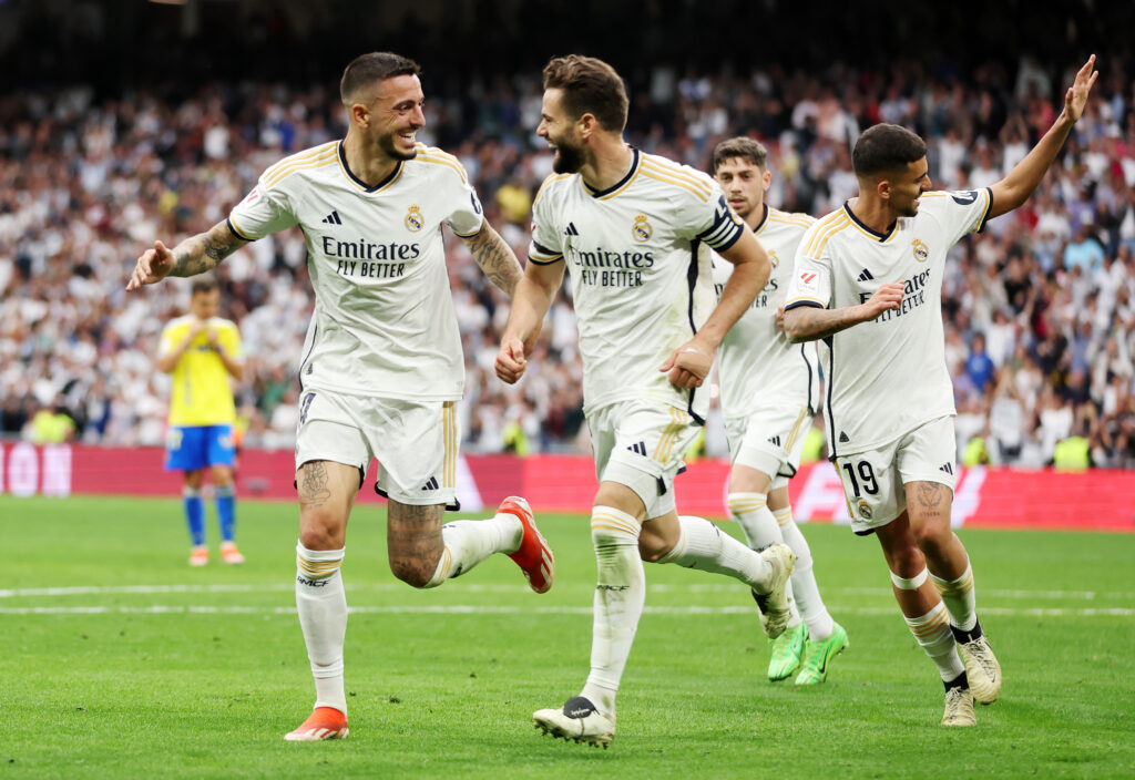 MADRID, SPAIN - MAY 04: Joselu of Real Madrid celebrates scoring his team's third goal with teammate Nacho Fernandez during the LaLiga EA Sports match between Real Madrid CF and Cadiz CF at Santiago Bernabéu Stadium on May 04, 2024 in Madrid, Spain.