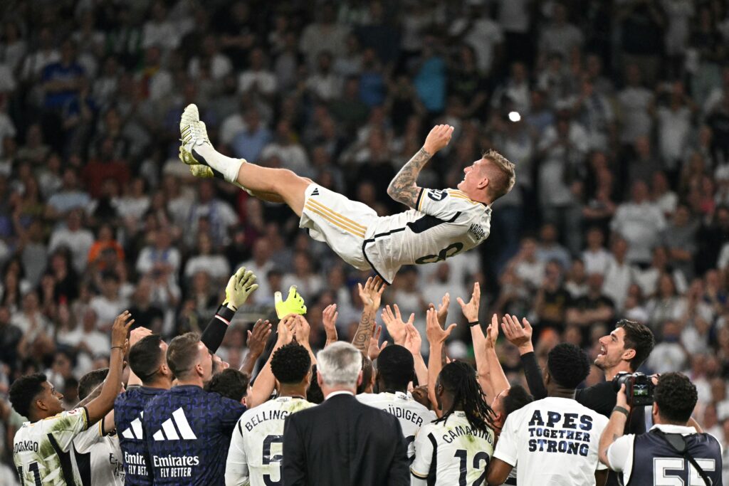 TOPSHOT - Real Madrid's German midfielder #08 Toni Kroos is thrown in the air by teammates during the Spanish league football match between Real Madrid CF and Real Betis at the Santiago Bernabeu stadium in Madrid on May 25, 2024. Real Madrid's German international midfielder Toni Kroos announced he will retire from all football after Euro 2024. Before the European Championship, Kroos has a chance to win the Champions League with Real for a fifth time when they face Borussia Dortmund at Wembley on June 1.