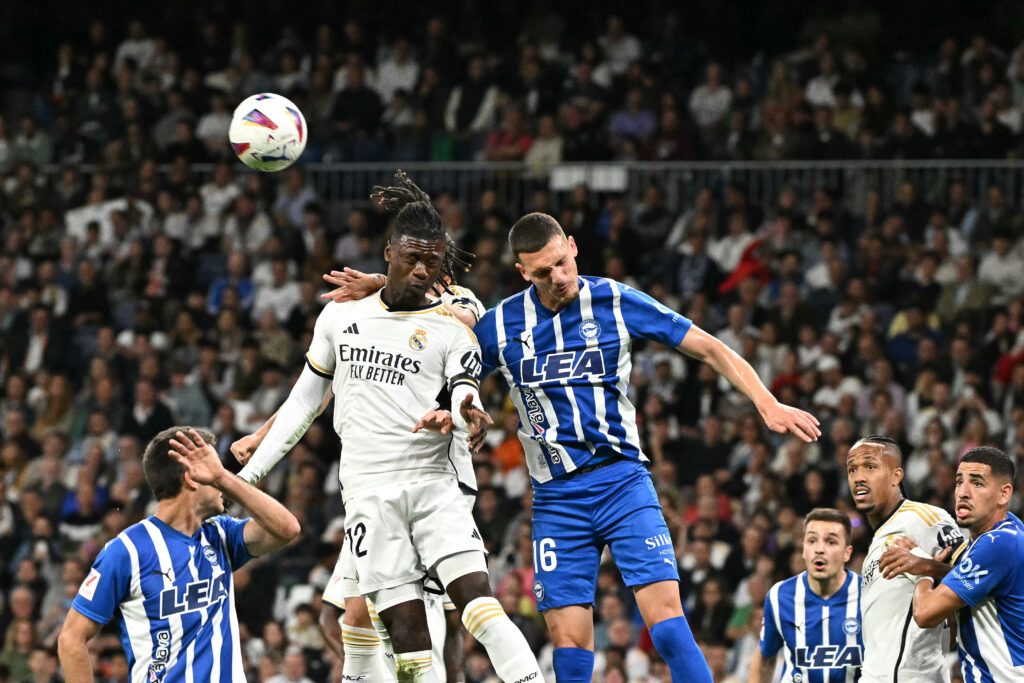 Real Madrid's French midfielder #12 Eduardo Camavinga and Alaves' Spanish defender #16 Rafa Marin head the ball during the Spanish league football match between Real Madrid CF and Deportivo Alaves at the Santiago Bernabeu stadium in Madrid on May 14, 2024.