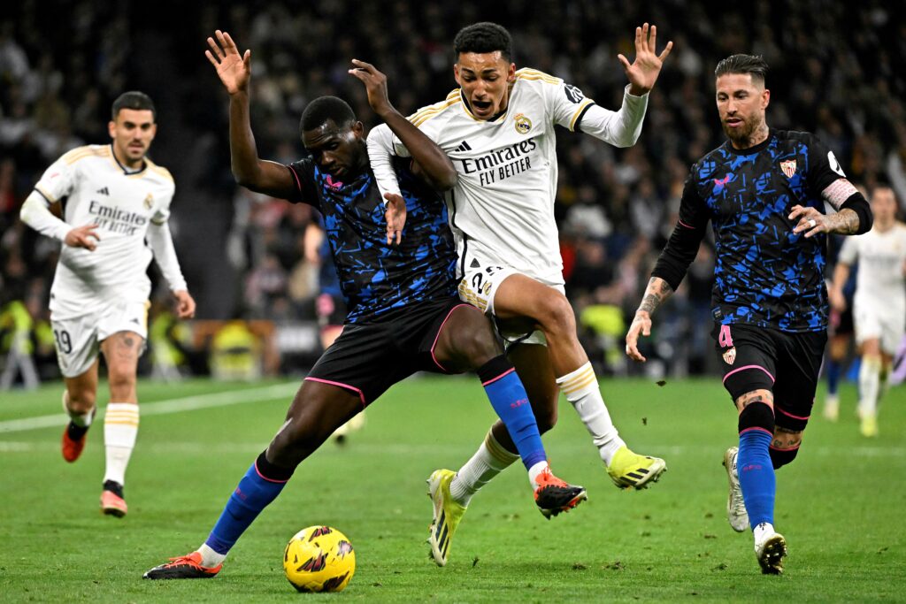 Real Madrid's Uruguayan forward #29 Alvaro Rodriguez vies with Sevilla's French defender #14 Tanguy Nianzou during the Spanish league football match between Real Madrid CF and Sevilla FC at the Santiago Bernabeu stadium in Madrid on February 25, 2024.