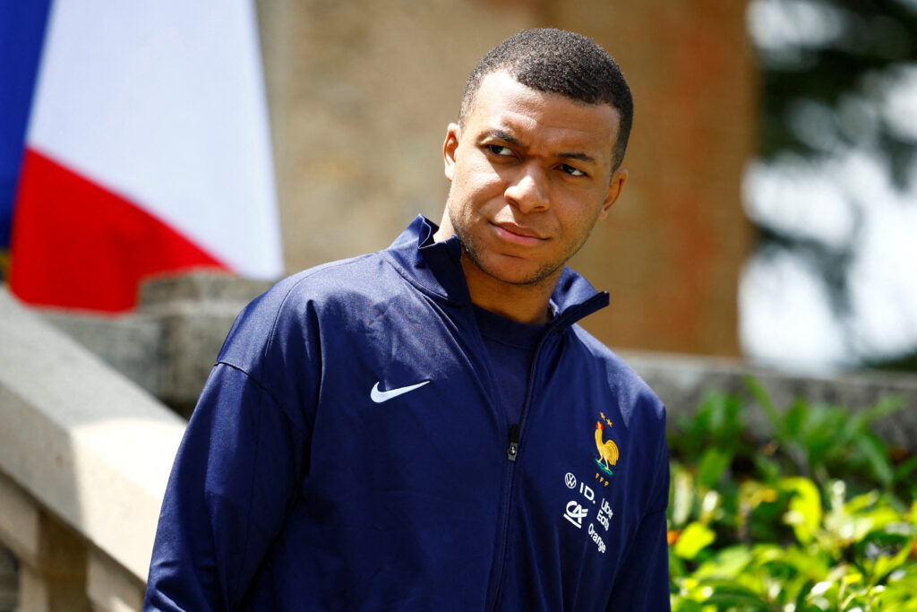 TOPSHOT - French forward Kylian Mbappe waits for the arrival of French President for a lunch at the team's training camp, as part of the team's preparation for the UEFA Euro 2024 European football championships in Clairefontaine-en-Yvelines on June 3, 2024.