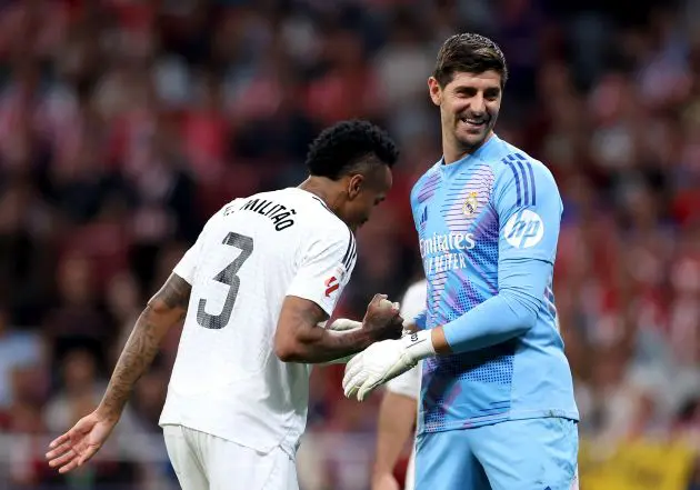 MADRID, SPAIN - SEPTEMBER 29: Eder Militao and Thibaut Courtois of Real Madrid interact during the LaLiga match between Atletico de Madrid and Real Madrid CF at Estadio Civitas Metropolitano on September 29, 2024 in Madrid, Spain.