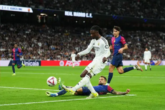 MADRID, SPAIN - OCTOBER 26: Eduardo Camavinga of Real Madrid is challenged by Inigo Martinez of FC Barcelona during the LaLiga match between Real Madrid CF and FC Barcelona at Estadio Santiago Bernabeu on October 26, 2024 in Madrid, Spain.