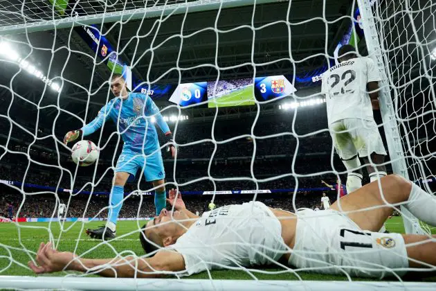 MADRID, SPAIN - OCTOBER 26: Andriy Lunin and Lucas Vazquez of Real Madrid react following FC Barcelona's fourth goal, scored by Raphinha (not pictured) during the LaLiga match between Real Madrid CF and FC Barcelona at Estadio Santiago Bernabeu on October 26, 2024 in Madrid, Spain.