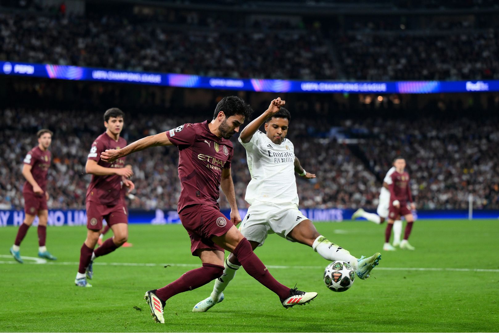MADRID, SPAIN - FEBRUARY 19: Ilkay Guendogan of Manchester City is challenged by Rodrygo of Real Madrid during the UEFA Champions League 2024/25 League Knockout Play-off second leg match between Real Madrid C.F. and Manchester City at Santiago Bernabeu Stadium on February 19, 2025 in Madrid, Spain.