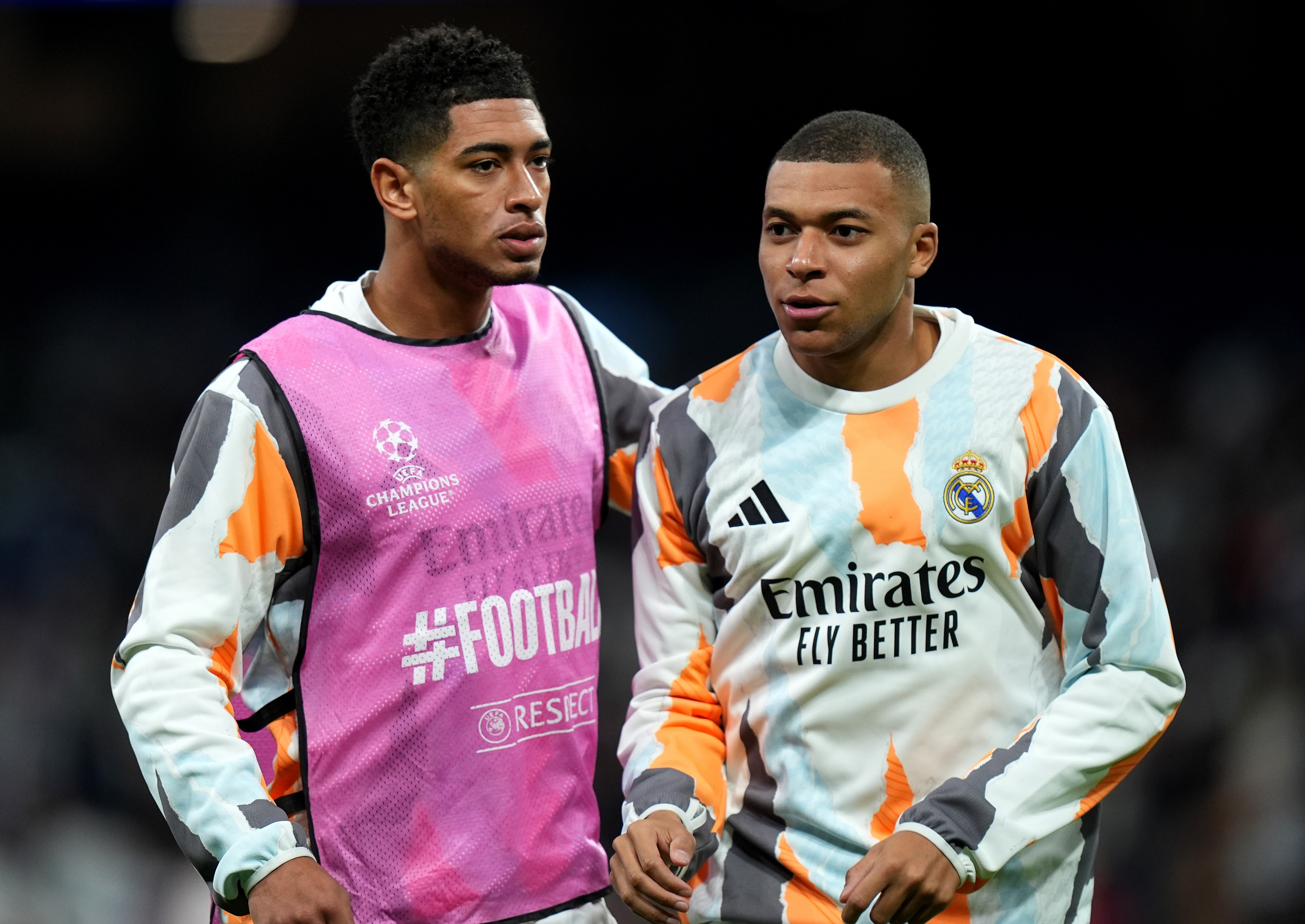 MADRID, SPAIN - JANUARY 22: Jude Bellingham of Real Madrid interacts with teammate Kylian Mbappe as they warm up prior to the UEFA Champions League 2024/25 League Phase MD7 match between Real Madrid C.F. and FC Salzburg at Estadio Santiago Bernabeu on January 22, 2025 in Madrid, Spain.