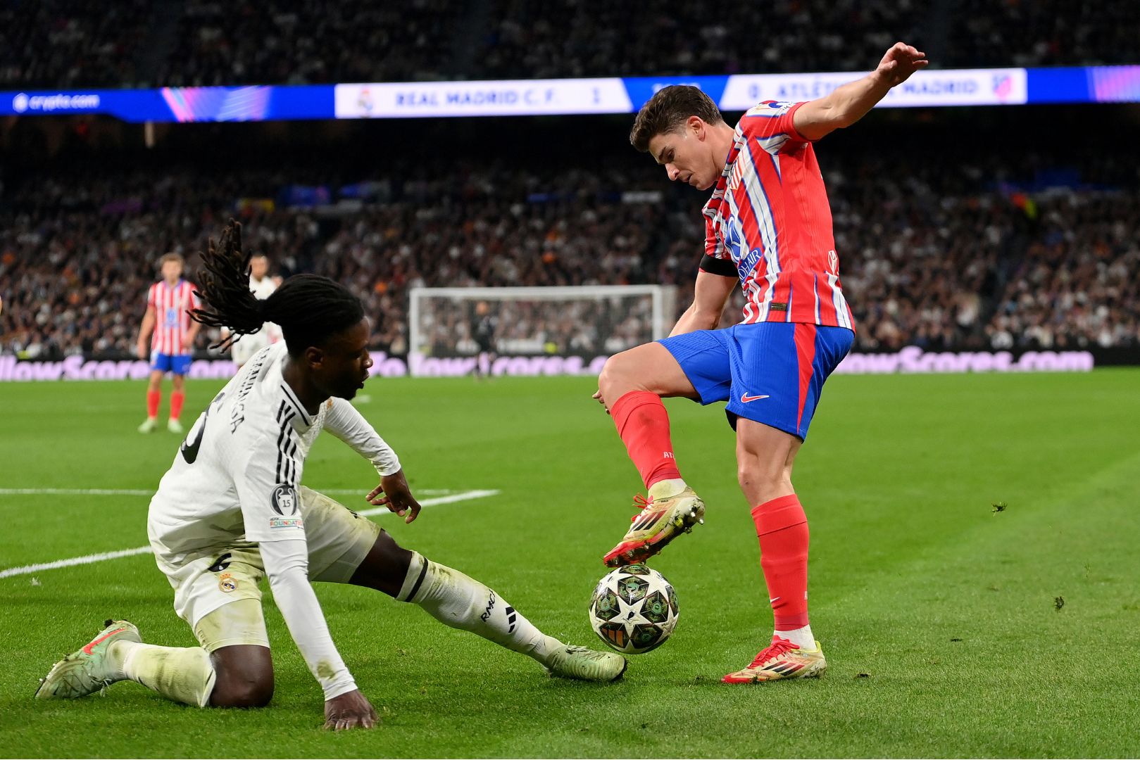 MADRID, SPAIN - MARCH 04: Julian Alvarez of Atletico de Madrid is challenged by Eduardo Camavinga of Real Madrid during the UEFA Champions League 2024/25 Round of 16 first leg match between Real Madrid C.F. and Atletico de Madrid at Santiago Bernabeu Stadium on March 04, 2025 in Madrid, Spain.