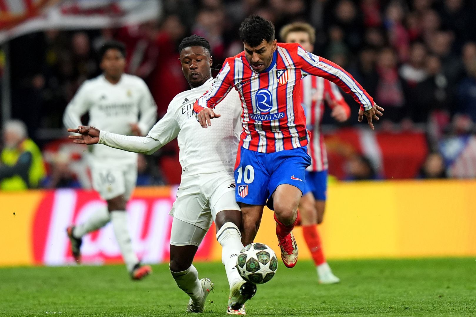 MADRID, SPAIN - MARCH 12: Angel Correa of Atletico de Madrid is challenged by Eduardo Camavinga of Real Madrid during the UEFA Champions League 2024/25 Round of 16 second leg match between Atletico de Madrid and Real Madrid C.F. at Estadio Metropolitano on March 12, 2025 in Madrid, Spain.