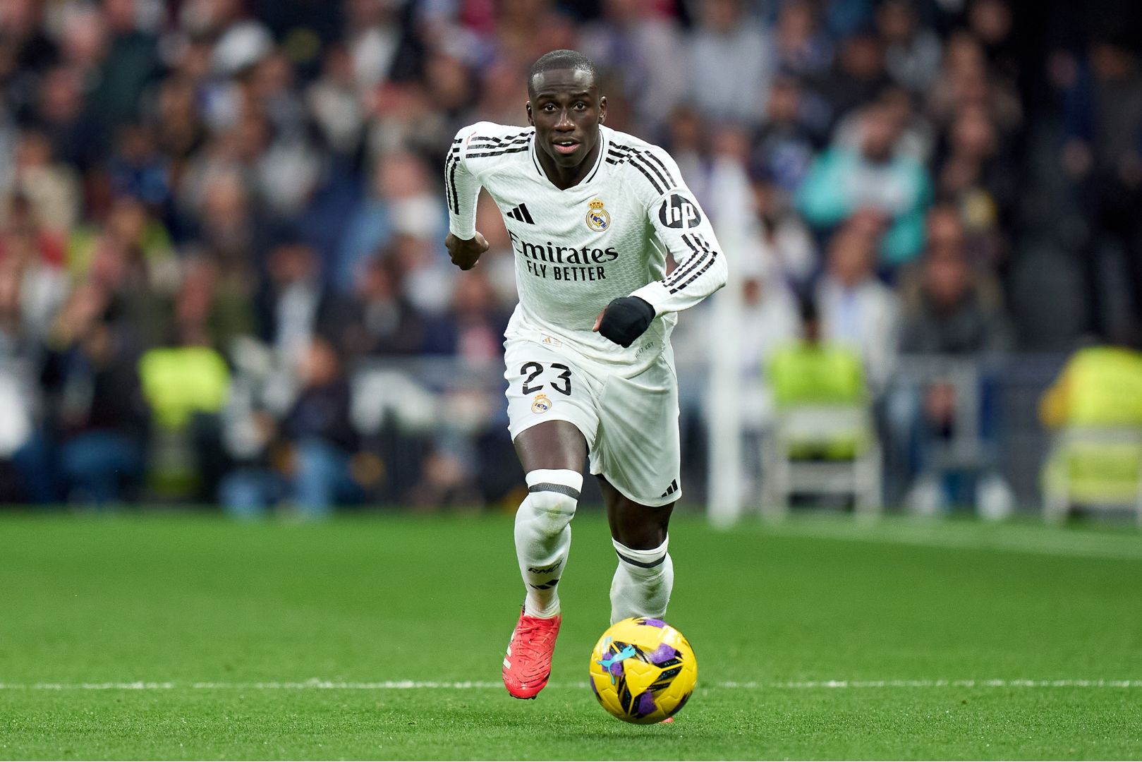 MADRID, SPAIN - FEBRUARY 23: Ferland Mendy of Real Madrid runs with the ball during the LaLiga match between Real Madrid CF and Girona FC at Estadio Santiago Bernabeu on February 23, 2025 in Madrid, Spain.