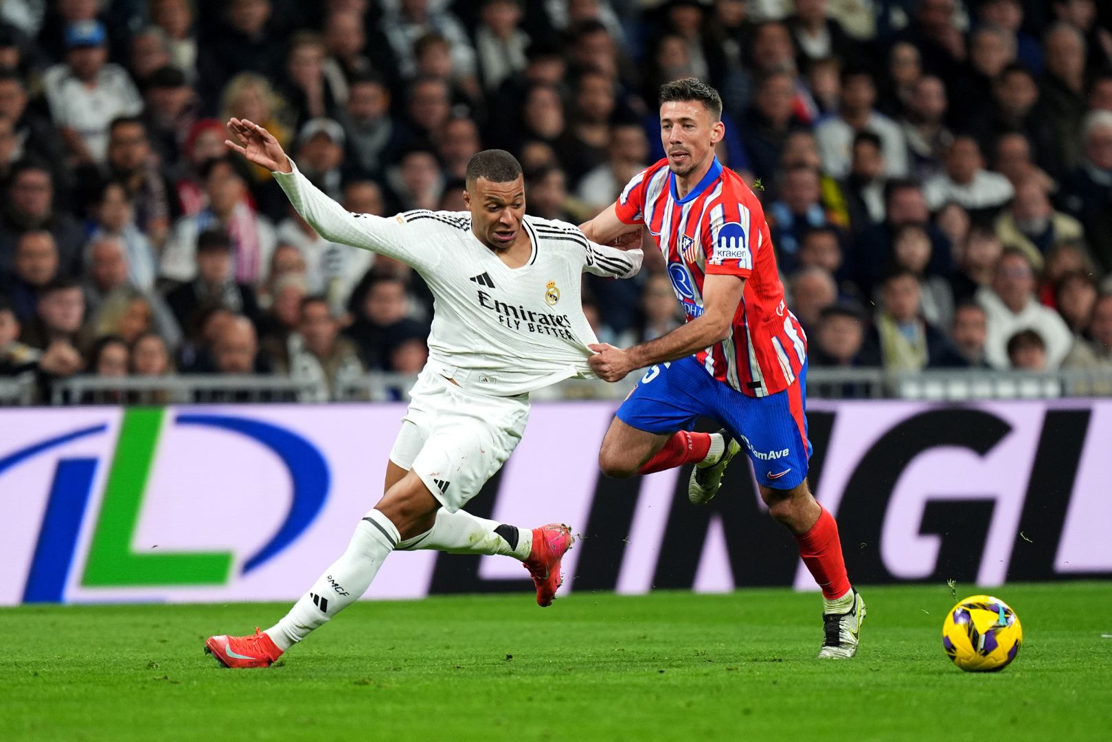 MADRID, SPAIN - FEBRUARY 08: Kylian Mbappe of Real Madrid is challenged by Clement Lenglet of Atletico de Madrid during the LaLiga match between Real Madrid CF and Atletico de Madrid at Estadio Santiago Bernabeu on February 08, 2025 in Madrid, Spain.